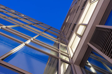 Naklejka premium Modern architecture with glass facade under blue sky at dusk. Gdansk. Poland.