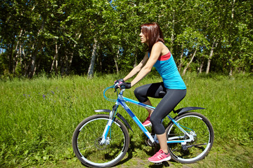 Fototapeta na wymiar Young woman and bike