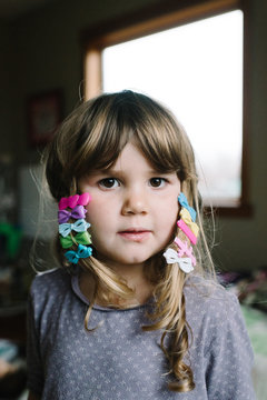 Portrait of young girl with colourful hair clips in hair