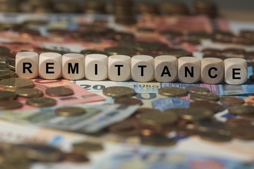 remittance - cube with letters, money sector terms - sign with wooden cubes - obrazy, fototapety, plakaty