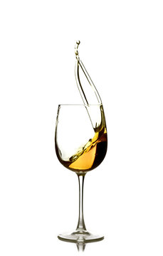 Splash Of White Wine In The Glass On A White Background