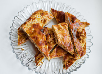 Chunks of fish cake lie on a glass plate. Close-up.
