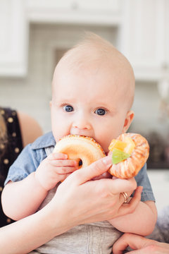  Baby boy toddler eat sweet donut.