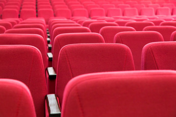 Empty auditorium. 
Rows of red seats in an empty concert hall.