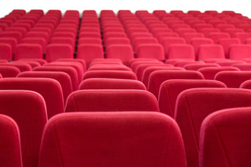 Empty auditorium. 
Rows of red seats in an empty concert hall.