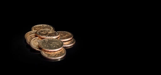 Heap of coins on black background. Business concept.