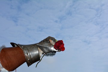 Hart aber herzlich - eine Eiserne Ritterhand hält rote Rose fest in der Faust 
