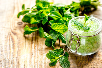 organic cosmetics with herbal extracts of mint on wooden background
