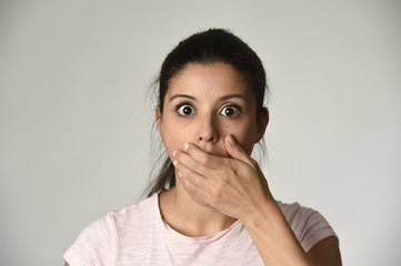 young beautiful Spanish surprised woman amazed in shock and surprise covering mouth