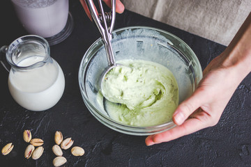 organic ice cream homemade process on dark background with hands