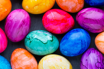 Easter eggs painted in colors on a pattern background.
