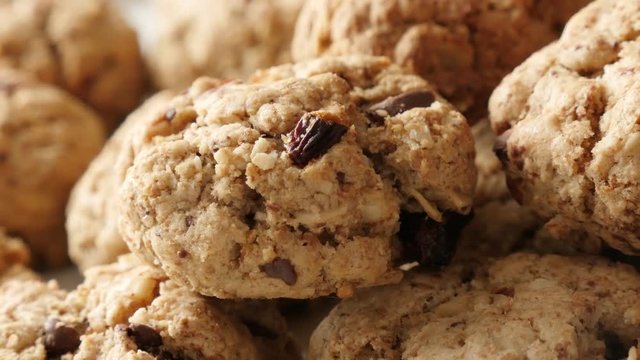 Close-up oatmeal homemade biscuits served on plate slow pan 4K 2160p 30fps UHD footage - Chocolate chip cookies on pile shallow DOF 3840X2160 UltraHD panning video 