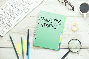 marketing strategy with keyboard and stationary on table