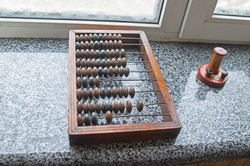 Old wooden abacus on granite background