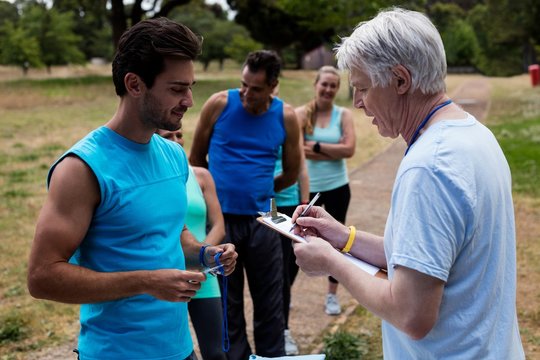 Volunteer registering athletes name for race - Powered by Adobe