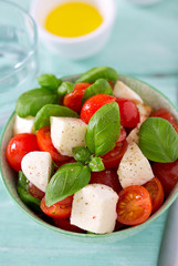 caprese salad on turquoise background