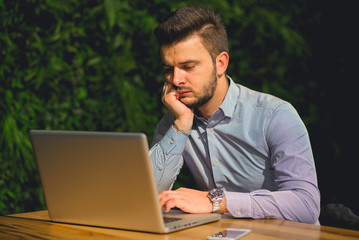 Fototapeta premium Young businessman working on computer