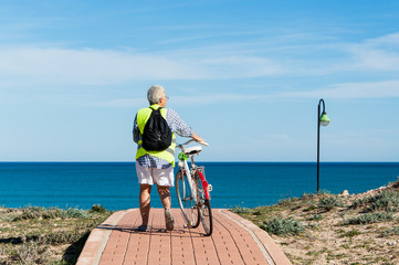 Senior woman traveling with bike