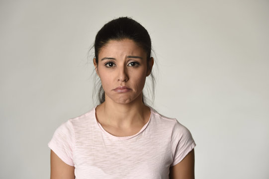 young beautiful hispanic sad woman serious and concerned in worried depressed facial expression