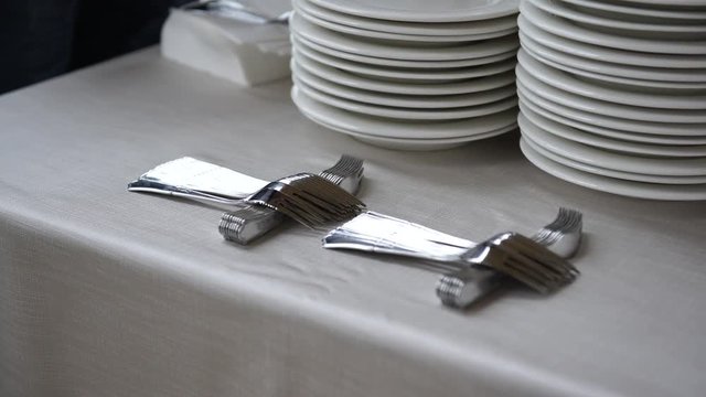 Wedding catering preparation, a waiter putting down forks for the appetisers , 4K