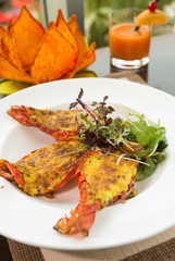 Beautiful and delicious giant oven roasted tiger prawns with lemongrass and five-spiced sabayon. Vietnamese seafood dish, served on a white plate.