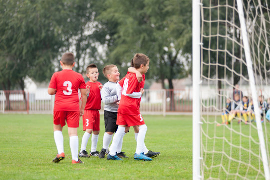 Young soccer football players celebrating goal
