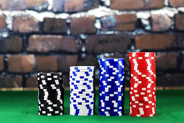 Columns of poker chips on green poker table