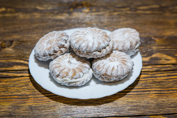 The cookies strewed with white powder against a dark background