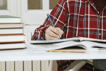 closeup of the hand of the child writing on the desk of house or the school