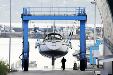 Fototapeta premium sailboat in shipyard for repair and maintenance in marina port