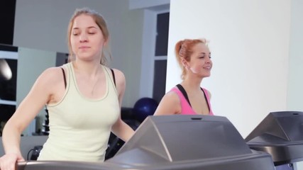 Female trains on elliptical trainers