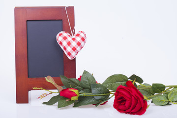 Red rose, red  hearts and writing board