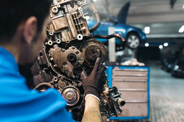 Fototapeta na wymiar Professional Mechanic Repairing Car Engine.