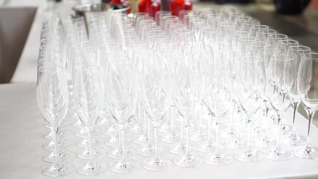 Wedding catering preparation, flutes and glasses waiting too be filled with the welcome drink, selective focus, 4K