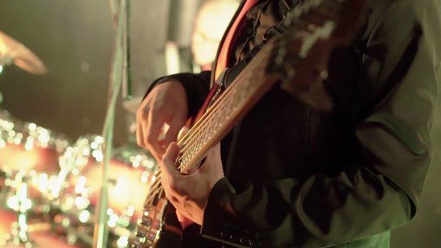 Man playing guitar in nightclub shot
