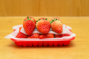 side view fresh strawberries pack on wood table