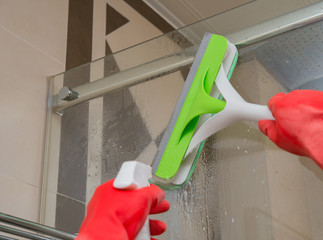 male cleaning glass with brush and chemical sprqy concept of domestic cleaning