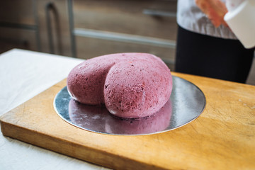 The pink biscuit cake in the form of heart on cutting board
