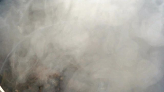 Boiling water in pot above the fire during Shrovetide carnival. Close up