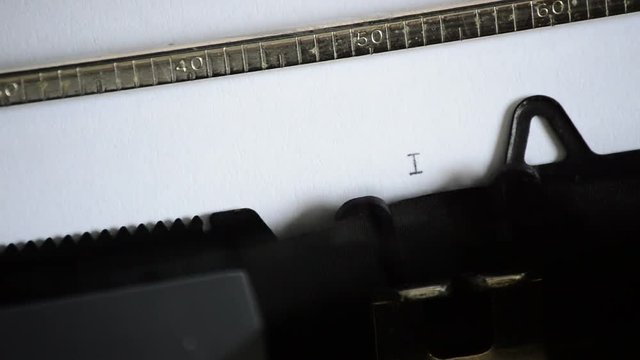 Typing the word INFORMATION with an old manual typewriter