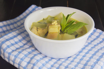 Green pork curry with old wooden background , Thai cuisine