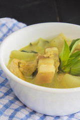 Green pork curry with old wooden background , Thai cuisine