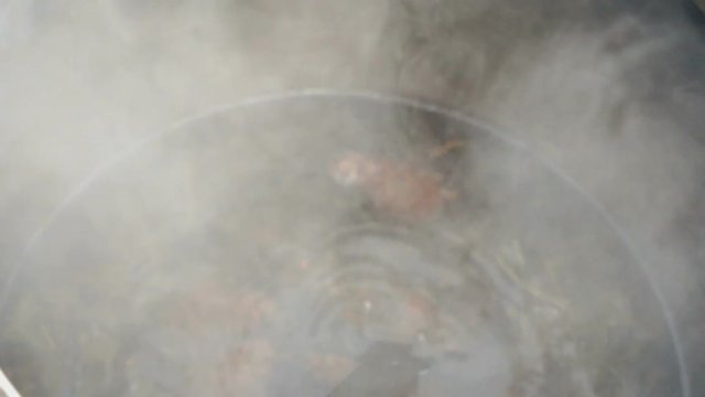 Boiling water in pot above the fire during Shrovetide carnival. Close up