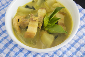 Green pork curry with old wooden background , Thai cuisine