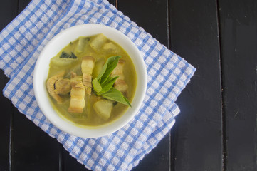Green pork curry with old wooden background , Thai cuisine