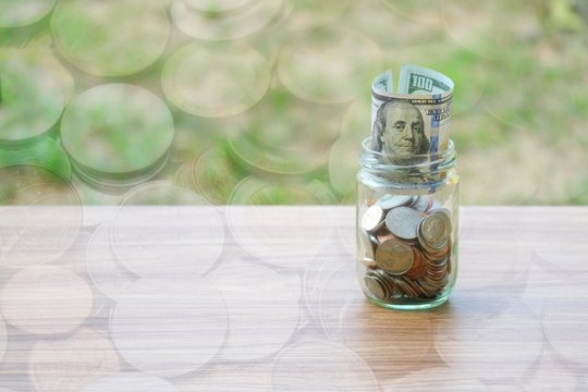 Dollar coin and banknote cash saving in glass jar, finance saving concept, double exposure