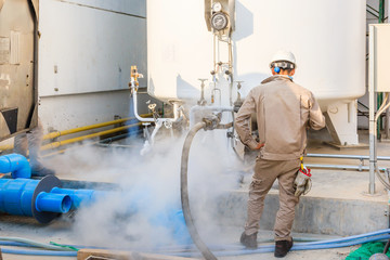 Technician fill with liquid nitrogen with Nitrogen storage tank at new factory - obrazy, fototapety, plakaty