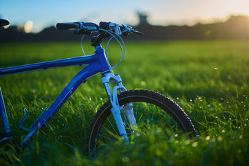 Bicycle on grass field in the morning