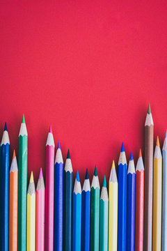 coloring pencils on a red background