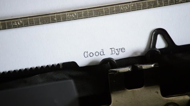 Typing the expression Good Bye with an old manual typewriter
